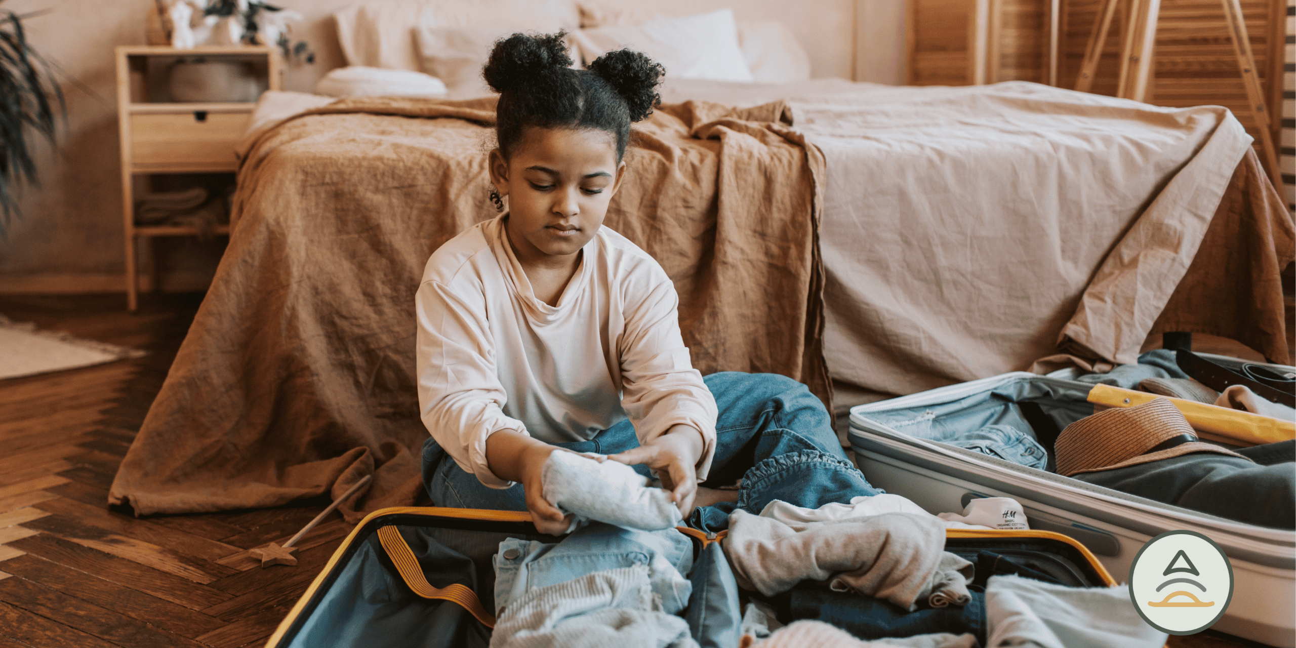 Young child packing a suitcase